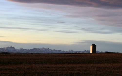 Film crew working on set in Alberta with Calgary skyline in background