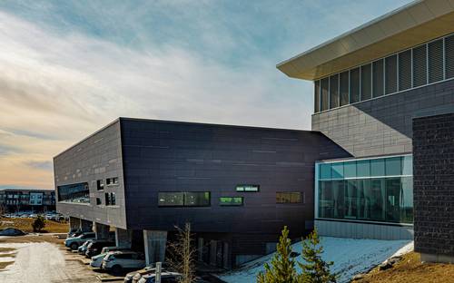 Modern Alberta innovation lab or tech office with business team and R&D equipment