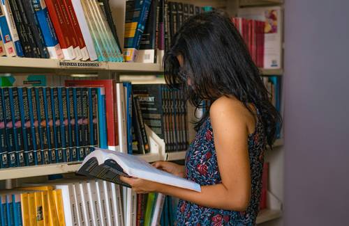 Alberta university student studying with textbooks and tax forms, representing education credits