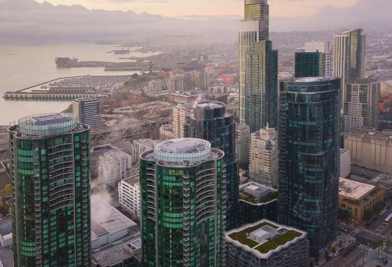 Modern Vancouver business district with downtown towers and a diverse corporate team in a meeting