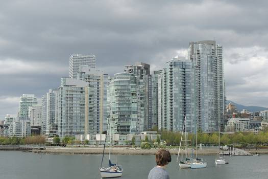 A family reviewing tax forms in Vancouver, British Columbia, with a city skyline in the background, representing the BC Climate Action Tax Credit