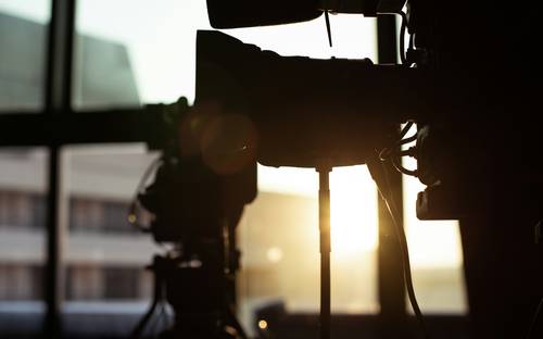 Film crew shooting on Vancouver set and digital media studio with monitors