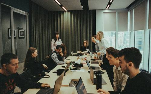 Modern BC business team in a workplace setting discussing training and apprenticeship