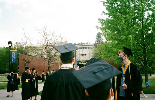 A university campus in Canada, a graduation cap, and a student holding a tax form for tuition credits