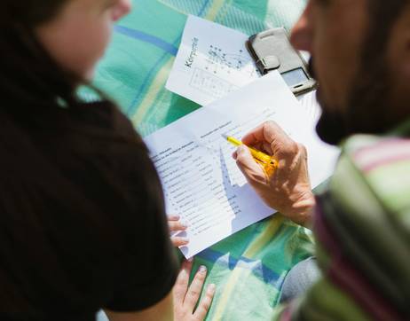 A Canadian doctor reviewing a disability tax credit form with a family, illustrating the DTC application process