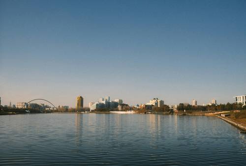 Manitoba tax forms with Winnipeg skyline in the background, representing provincial tax breaks in Manitoba