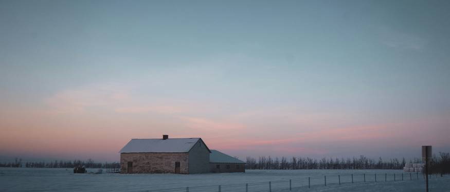 Energy-efficient Manitoba business with solar panels and winter landscape