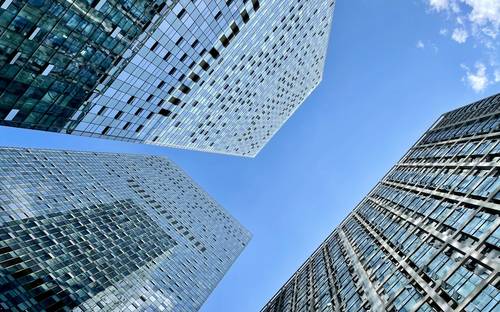 Modern Moncton business district skyline with office towers and a business team collaborating