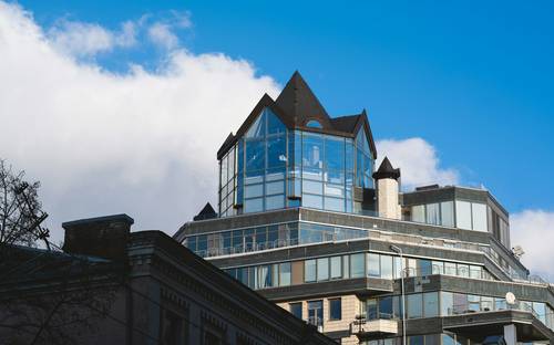 Modern Halifax business district with glass towers and a diverse business team in a meeting