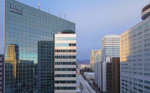 Regina business district skyline with professionals collaborating in a modern Saskatchewan office