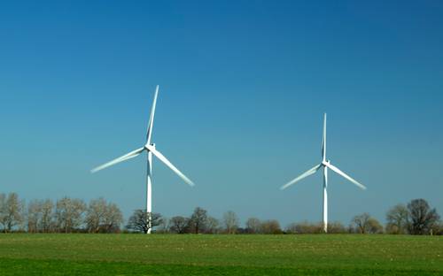 Saskatchewan solar farm with wind turbines representing clean technology and renewable energy investment