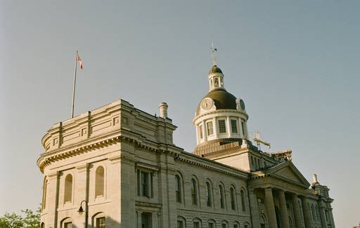 Saskatchewan tax forms with Regina skyline in the background, representing provincial tax breaks in Saskatchewan