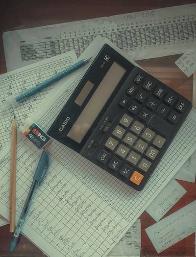 A person using a calculator and reviewing Canadian tax paperwork, representing financial planning